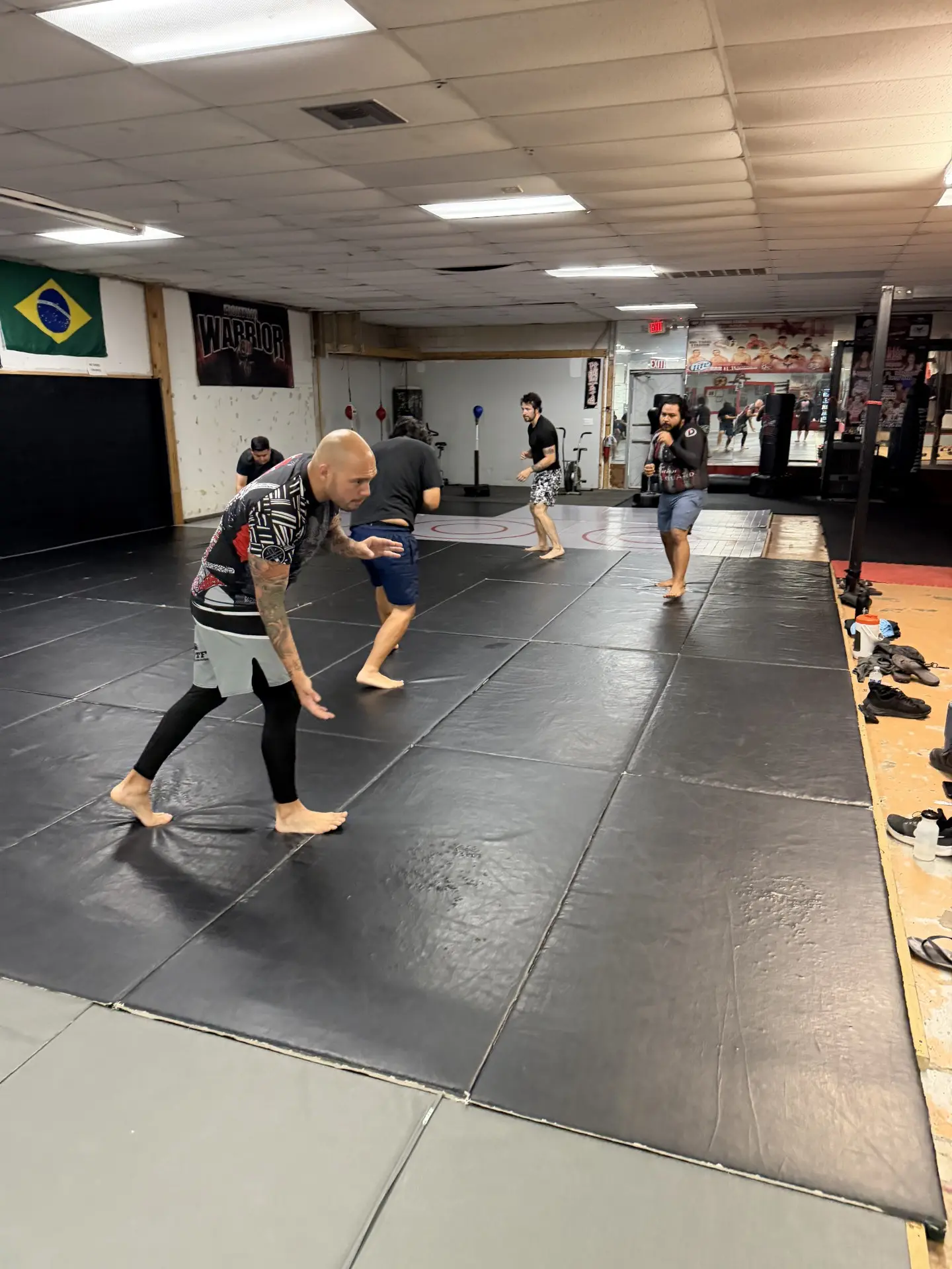 Guardians students drilling wrestling stances on the academy mats